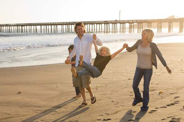 A family enjoys a stroll on the beach