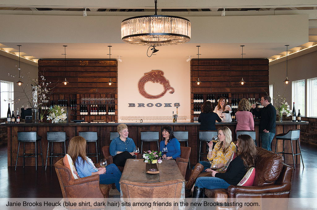 Janie Brooks Heuck (blue shirt, dark hair) sits among friends in the new Brooks tasting room.